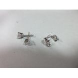 Two pairs of diamond set ear studs, the first pair each with a princess cut diamond four claw set to