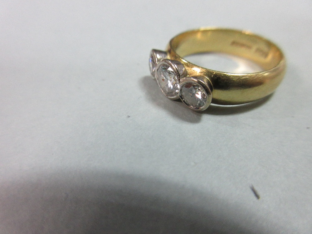 A collet set three stone diamond ring in 18ct gold, the graduated round brilliant cut diamonds - Image 2 of 5