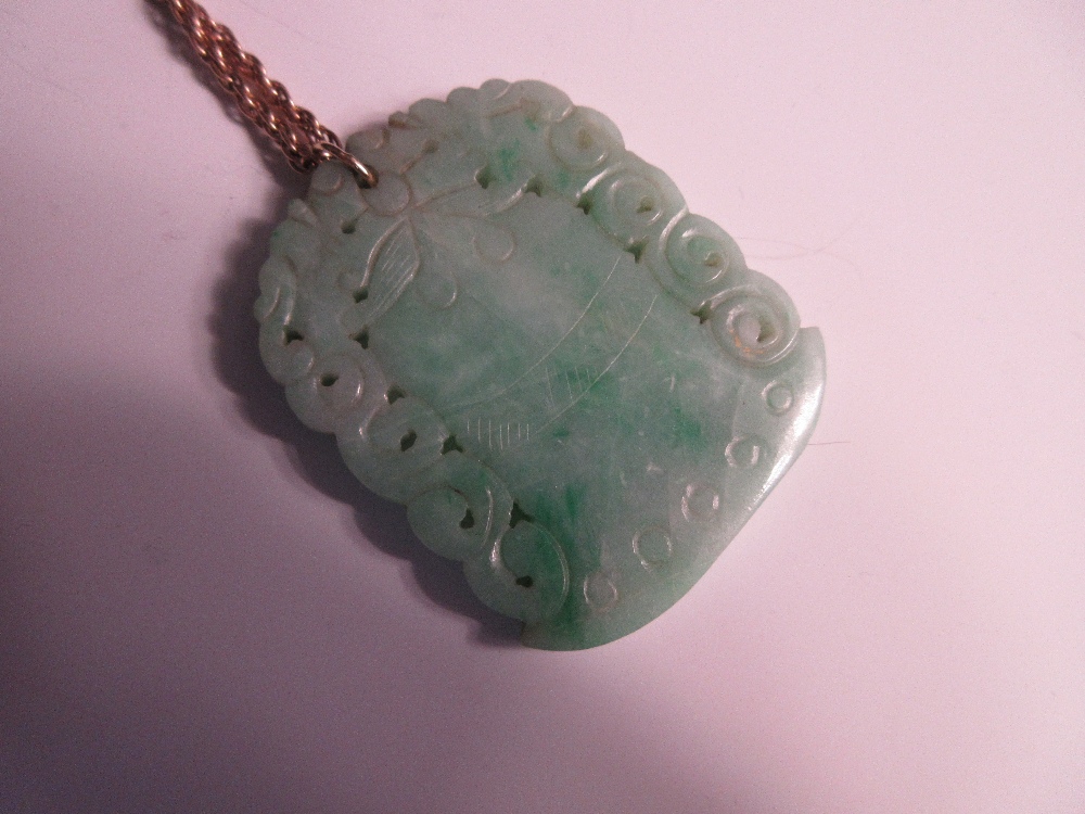 A carved jadeite jade pendant on a ropetwist chain, the mottled light green jade plaque carved on - Image 3 of 4