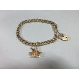 A diamond and gemset champagne charm on a 9ct gold bracelet, the charm, stamped '750', in the form