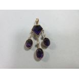 An unusual antique amethyst and seed pearl pendant, composed of a pentagonal cut deep purple