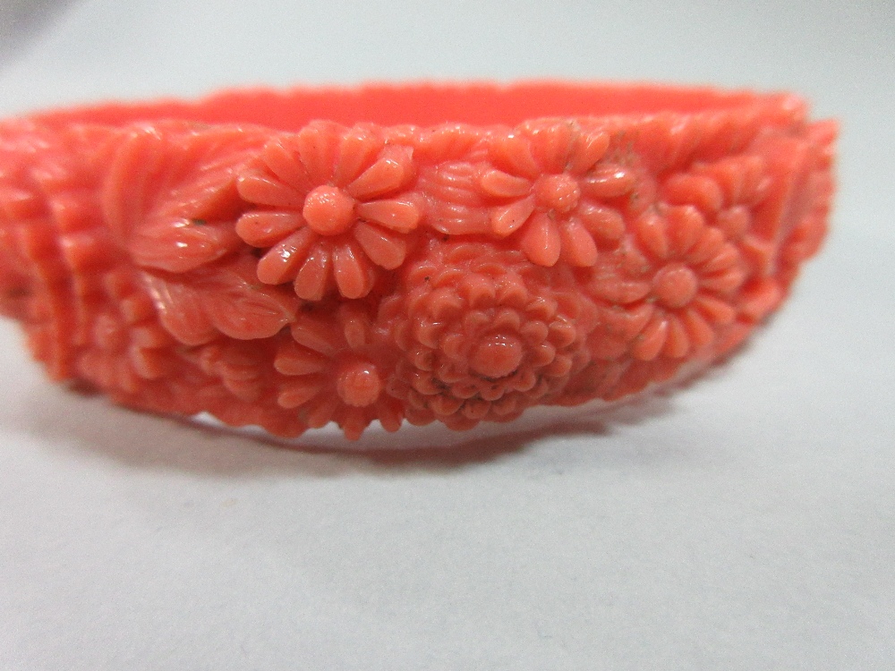 A graduated strand of coral beads and an early plastic carved 'coral' bangle, the necklace of - Image 6 of 7