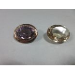 An amethyst brooch together with a large loose oval cut citrine, the brooch with an oval cut