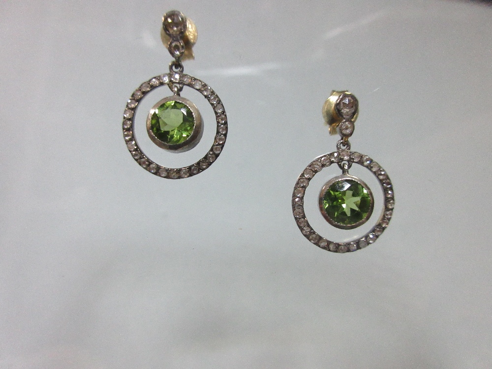 A pair of peridot and diamond earpendants, each post headed by two graduated rose cut diamonds