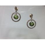 A pair of peridot and diamond earpendants, each post headed by two graduated rose cut diamonds