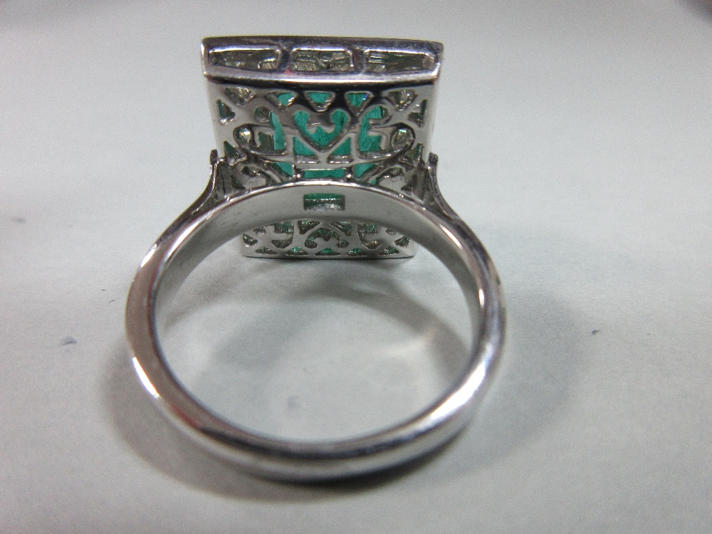 A large emerald and diamond cluster ring, the emerald cut emerald, estimated weight 4.78cts, above a - Image 5 of 8