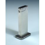 Dunhill - an electroplate table lighter, of rectangular engine turned design on wide octagonal base,