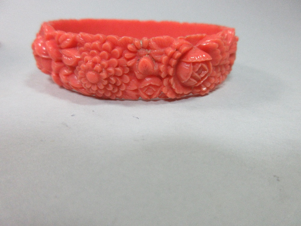 A graduated strand of coral beads and an early plastic carved 'coral' bangle, the necklace of - Image 4 of 7