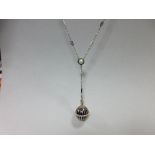 An enamel and diamond pendant watch suspended from a fancy link enamel and seed pearl necklace,