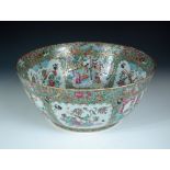 A 19th century Canton punch bowl, the figure reserves on the interior in framed topped by dragons