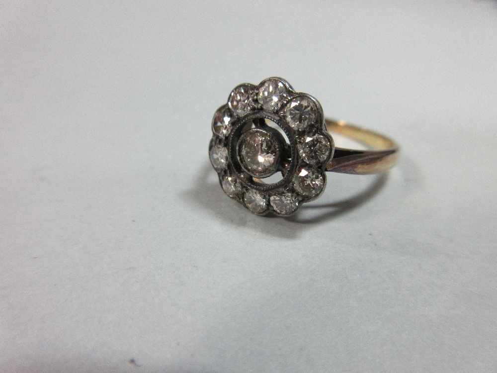 A diamond pierced cluster ring, with a central millegrain collet set round brilliant cut diamond - Image 3 of 7