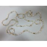 An opera length fancy pearl necklace with nugget spacers, with various sized and shaped freshwater