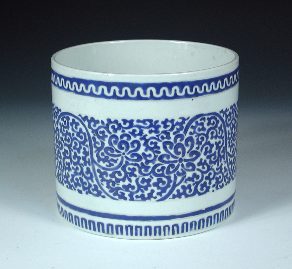 A Chinese overglaze blue brush pot, the exterior rim with a wavy line band above scrolling lotus and