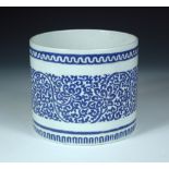 A Chinese overglaze blue brush pot, the exterior rim with a wavy line band above scrolling lotus and