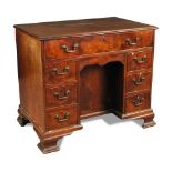 A George III mahogany kneehole desk, with rule moulded border, one long drawer, blind drawer,