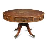 A Regency mahogany drum library table, faded leather lined revolving top, fitted alternate drawers