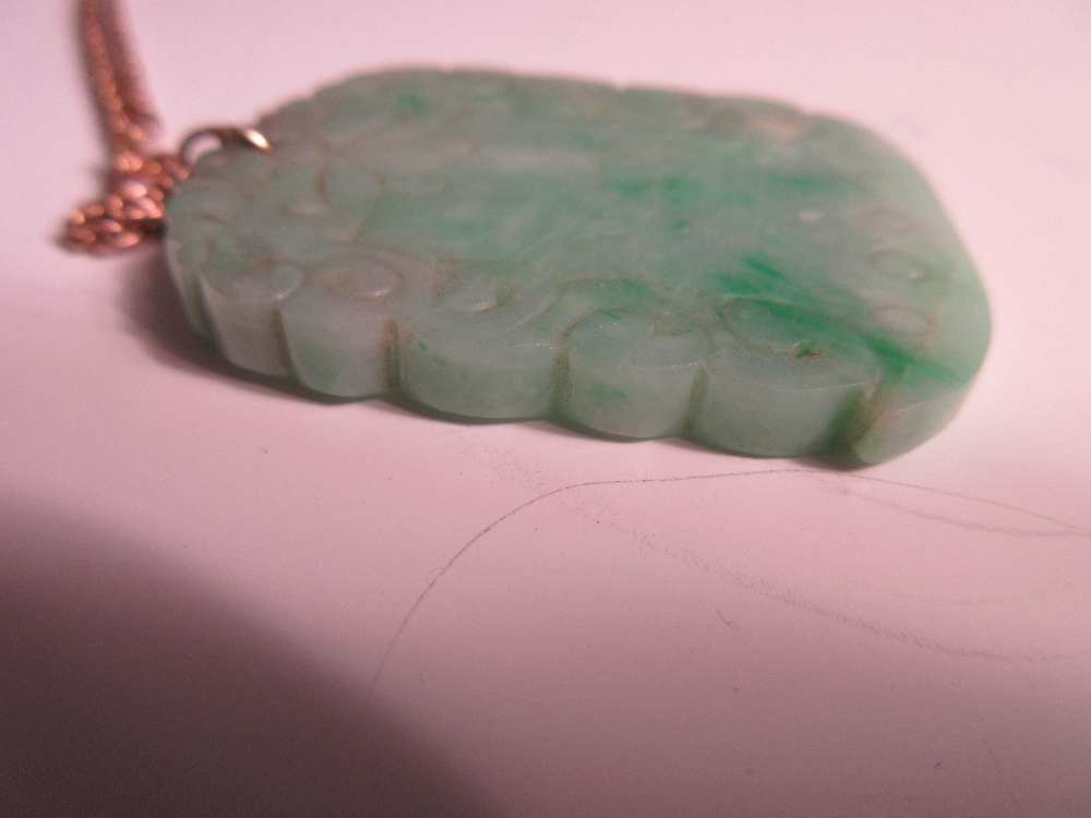 A carved jadeite jade pendant on a ropetwist chain, the mottled light green jade plaque carved on - Image 4 of 4