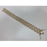 A 9 carat gold and white hardstone bracelet, the bi-coloured figure-of-eight links each set with a