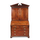 A George III mahogany bureau bookcase, circa 1770, with breakarch pediment, dentil cornice with