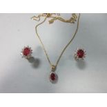 A pair of treated ruby and diamond cluster earstuds together with a similar pendant, each earring