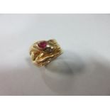A gemset snake ring, formed as a triple coil with head and tail to the front, with rose cut