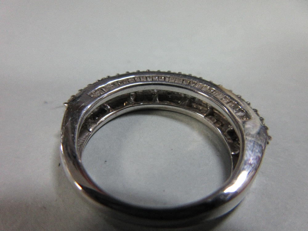 A diamond and white gold half band ring, with a channel set line of baguette cut diamonds between - Image 3 of 4