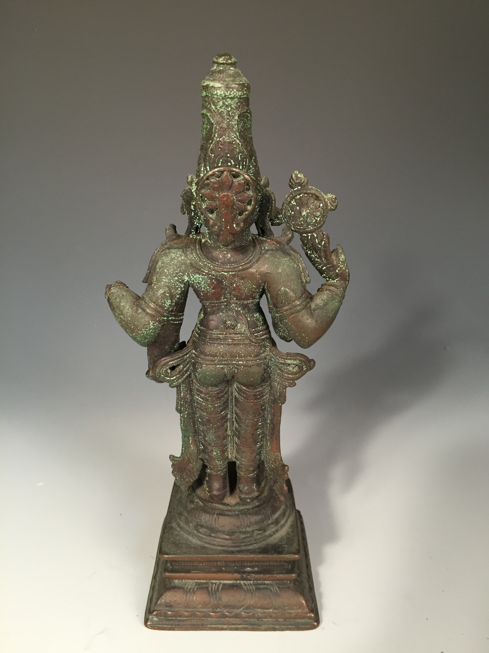 An Indian bronze figure, possibly Vishnu, the four-armed deity standing, his lower hands in - Image 3 of 4