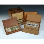 A collection of microscope slides and a slide cabinet. The pine slide cabinet with 12 trays each