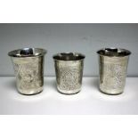 Three small Russian silver beakers, each of slightly tapering form, engraved variously with