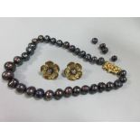 A matched suite of 18ct gold and black pearl earstuds and a black pearl necklace, each gold