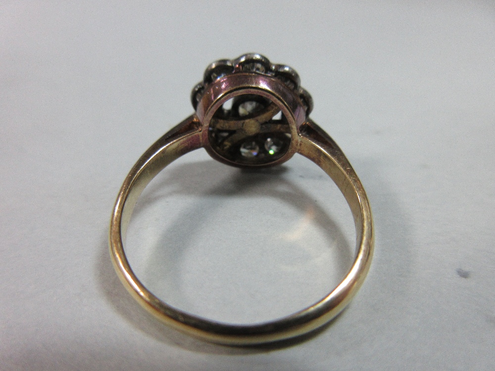 A diamond pierced cluster ring, with a central millegrain collet set round brilliant cut diamond - Image 5 of 7