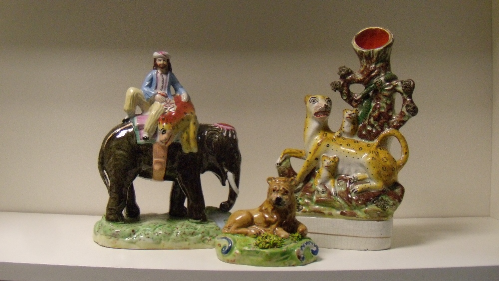 Three 19th century Staffordshire pottery figures, the 'Walton' lion reclining on a green mound, - Image 2 of 4