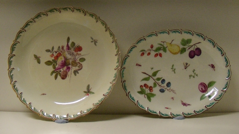 Two 'Red Anchor' Chelsea dishes painted with fruit within green and iron red feathered rims, the