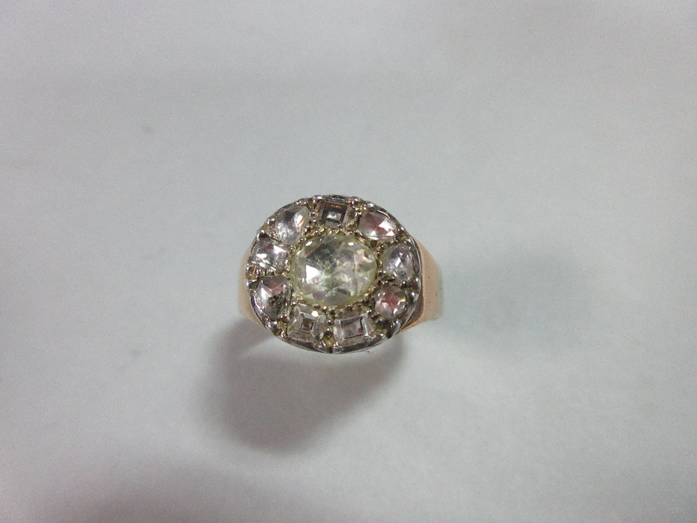 A 19th century diamond ring, the ring head, possibly originally a Georgian button, set to the centre