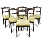 A set of six Regency faux rosewood dining chairs, with gilt brass mounts, cane seats and squab