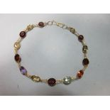 A multi gemset bracelet, each oval or round cut stone of rainbow hues and including amethyst,