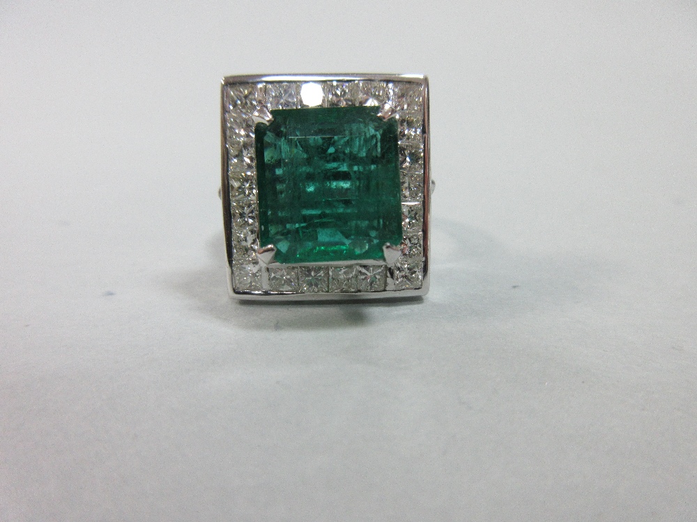 A large emerald and diamond cluster ring, the emerald cut emerald, estimated weight 4.78cts, above a - Image 2 of 8