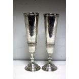 A small pair of Russian silver flutes, Moscow 1892, each raised on a circular beaded foot below a