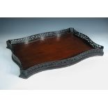 A Chippendale taste mahogany galleried tray, the serpentine form with pierced gallery, late 19th