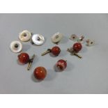 A small collection of gentleman's requisites, including four 1.3cm banded cornelian bead buttons and