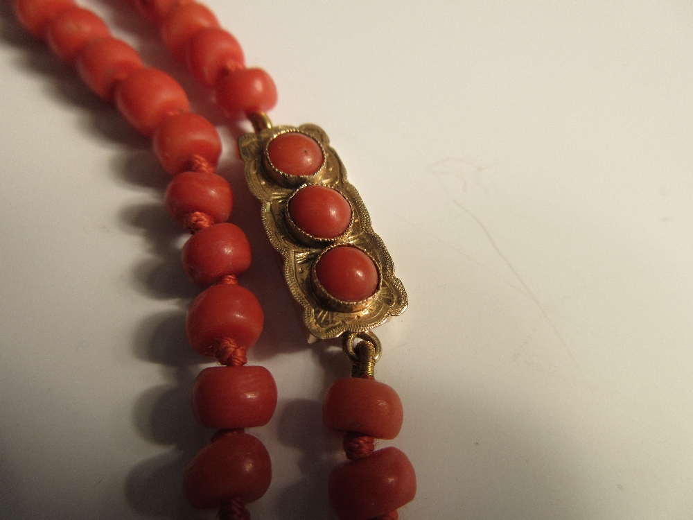 A two row red coral bead necklace, the uniform 5-6mm diameter tyre-shaped beads, individually - Image 2 of 4