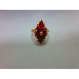 A modern red hardstone ring, the four diaper step cut deep crimson red stones, believed to be