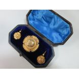 A Victorian brooch and earring suite in original fitted case, the brooch of geometric design as a