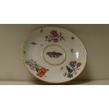 An 18th century Meissen ecuelle stand, the central butterfly painted within scattered flowers and