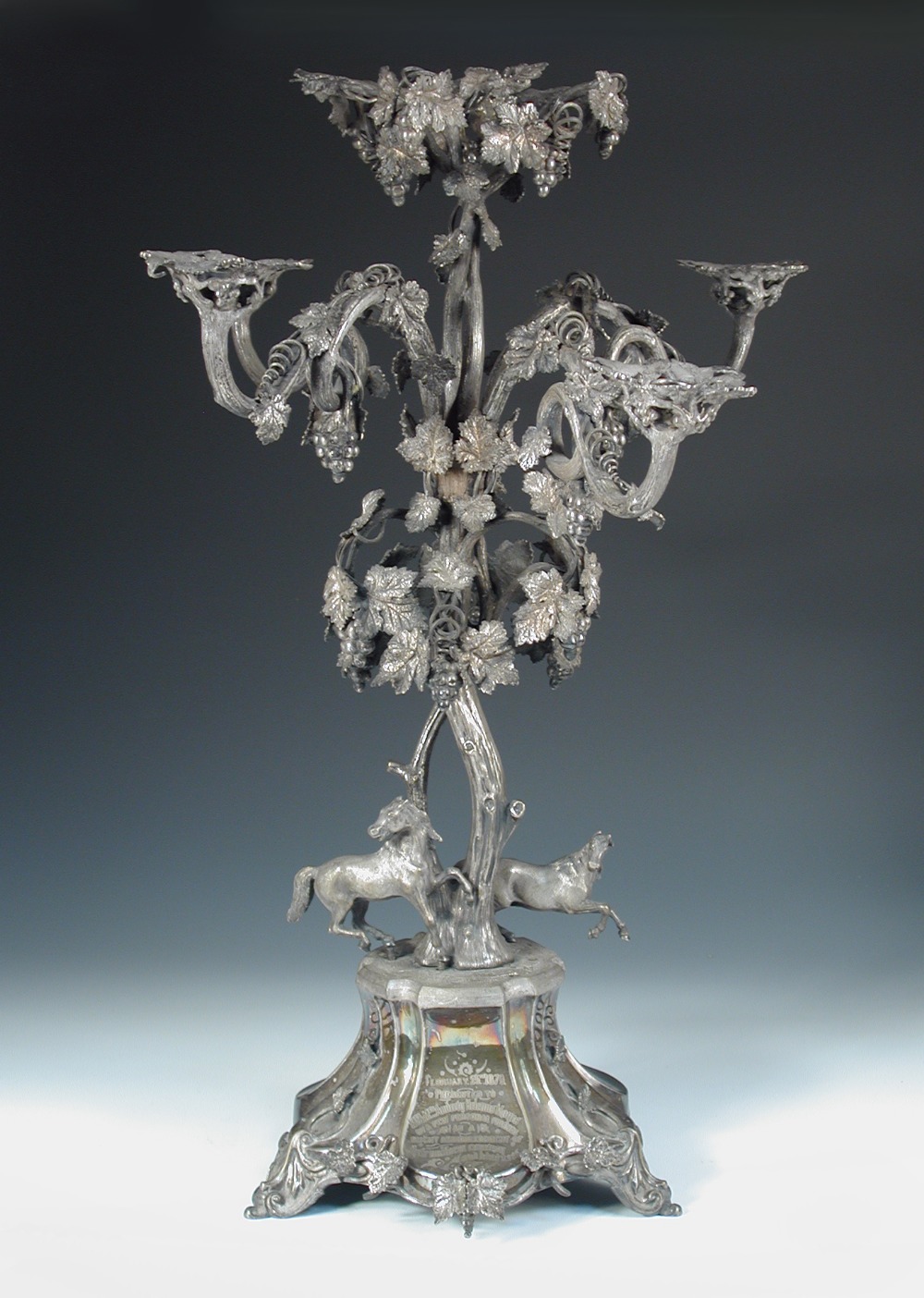 A large Victorian electroplated table centrepiece, by Mappin & Webb, the triform base with applied