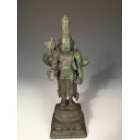 An Indian bronze figure, possibly Vishnu, the four-armed deity standing, his lower hands in