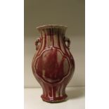 A Chinese flambe two handled vase, the ribbed flattened baluster vase with quatrefoil panels each