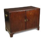 A George II mahogany cabinet, with concealed internal drawer and shaped shelf, side mounted brass