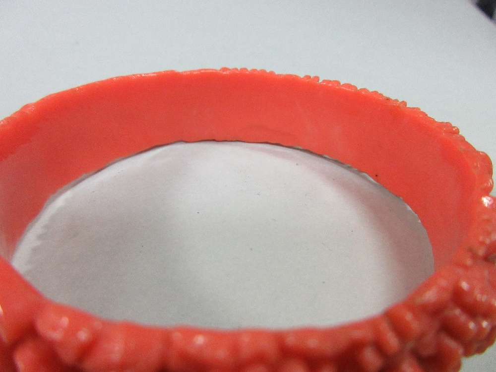 A graduated strand of coral beads and an early plastic carved 'coral' bangle, the necklace of - Image 5 of 7