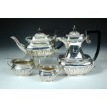 A matched four piece silver tea set, by Charles Boyton & Son Ltd, London 1912/1919, comprising:- a